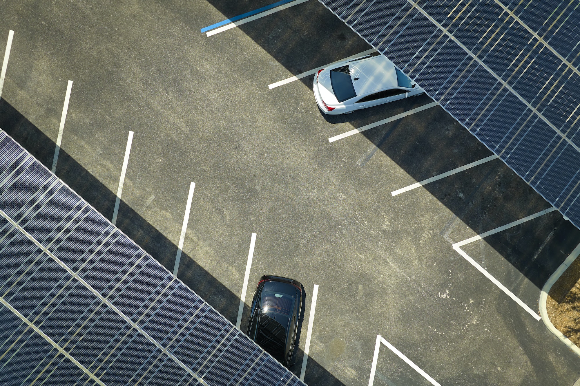Solar panels installed over parking lot for parked cars for effective generation of clean energy